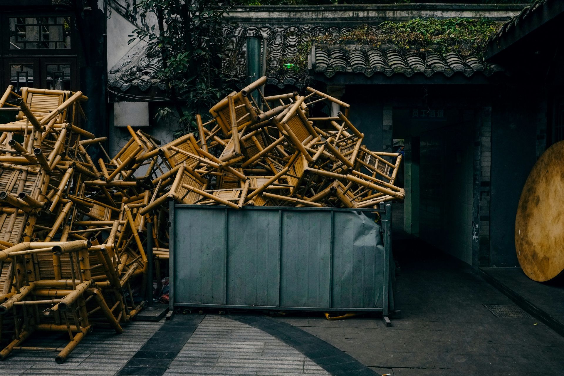 Chairs piled high in a metal container
